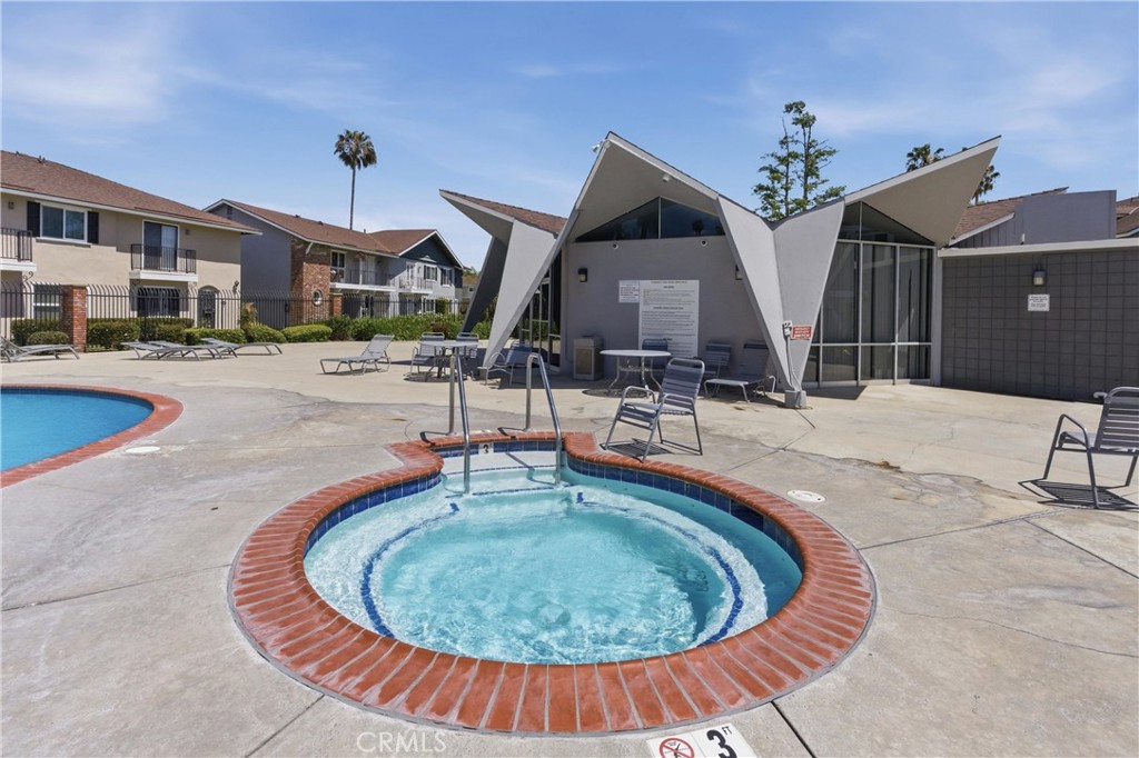 3342 Bradbury Road, Unit 20 Los Alamitos, CA 90720 - Photo 31 of 32 a swimming pool with outdoor seating