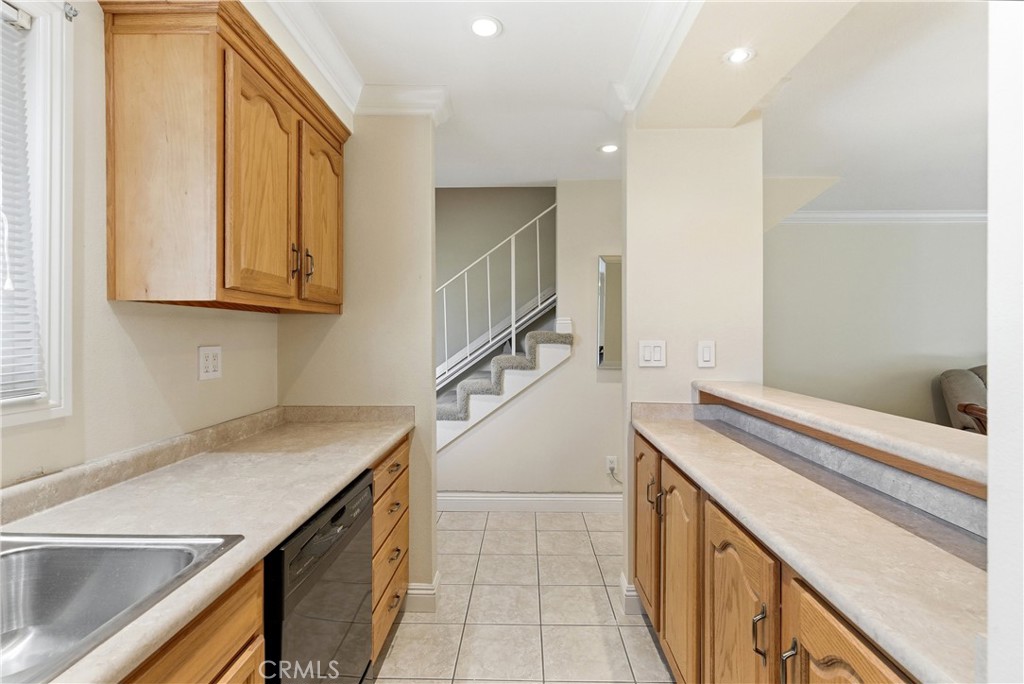 3342 Bradbury Road, Unit 20 Los Alamitos, CA 90720 - Photo 9 of 32 a kitchen with a sink and a cabinet with wooden floor