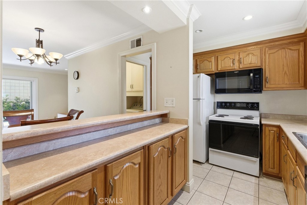 3342 Bradbury Road, Unit 20 Los Alamitos, CA 90720 - Photo 10 of 32 a kitchen with stainless steel appliances a sink and a stove