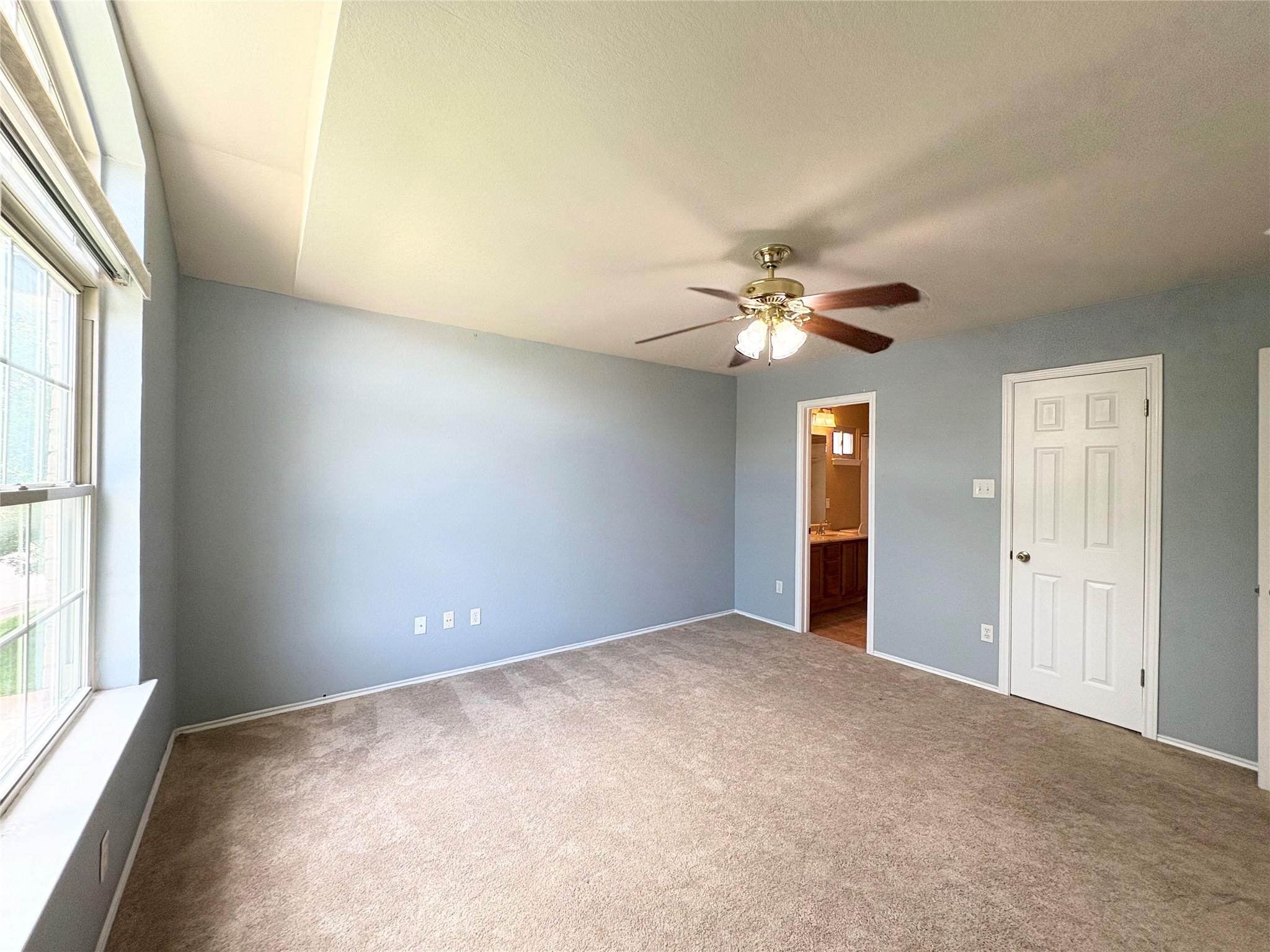 8103 Ephraim Road Austin, TX 78717 - Photo 25 of 35 An airy bedroom with a tray ceiling and a window providing natural illumination.