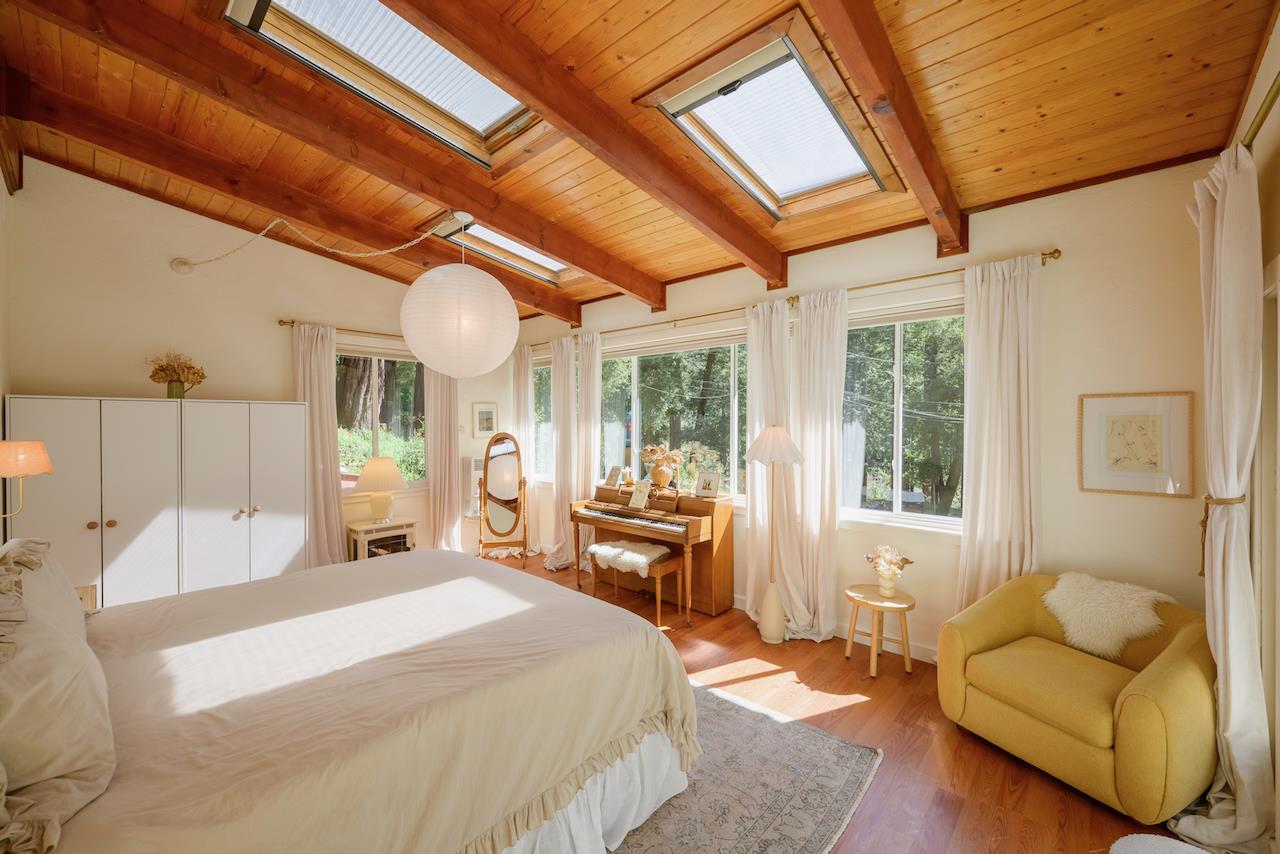 10735 Westwood Road Felton, CA 95018 - Photo 23 of 118 a large bedroom with a bed and a large window with the outer view