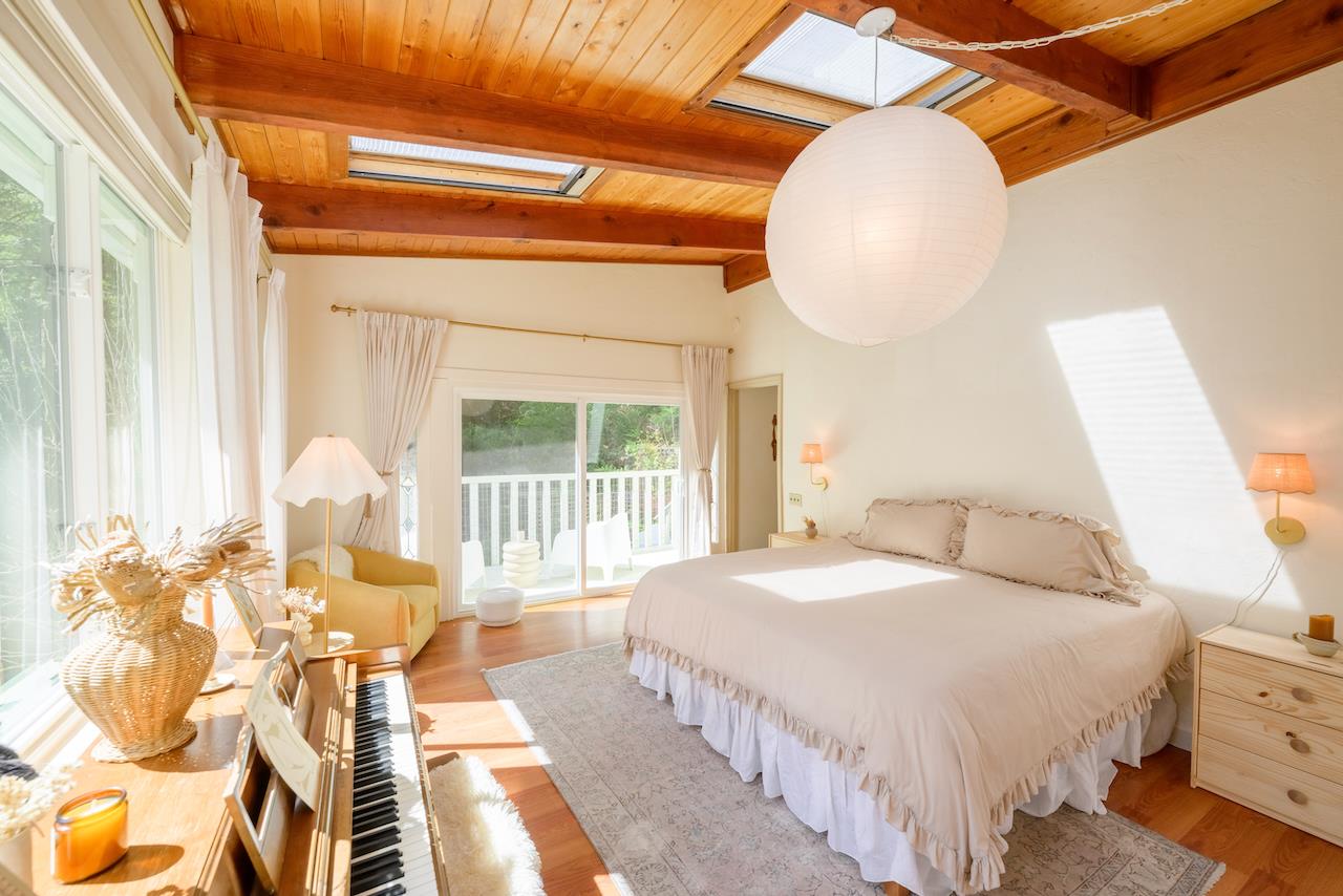 10735 Westwood Road Felton, CA 95018 - Photo 4 of 118 a bedroom with a bed and a chandelier