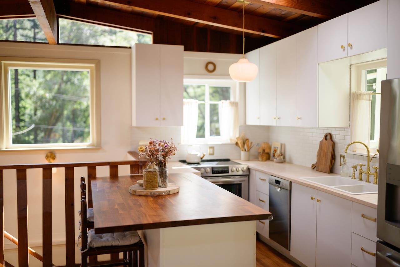 10735 Westwood Road Felton, CA 95018 - Photo 63 of 118 a kitchen with a stove a sink a kitchen island with a dining table and chairs