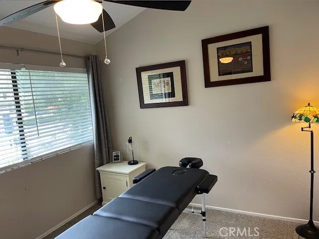 a view of a workspace with furniture and a window
