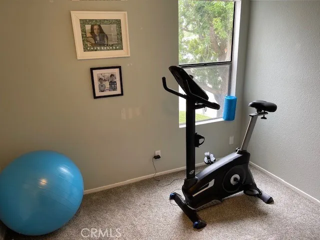 a room with gym equipment and a large window