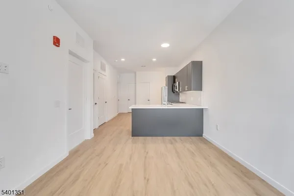 a view of kitchen with wooden floor and electronic appliances