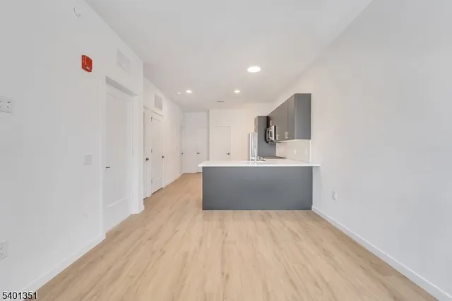 a view of kitchen with wooden floor and electronic appliances