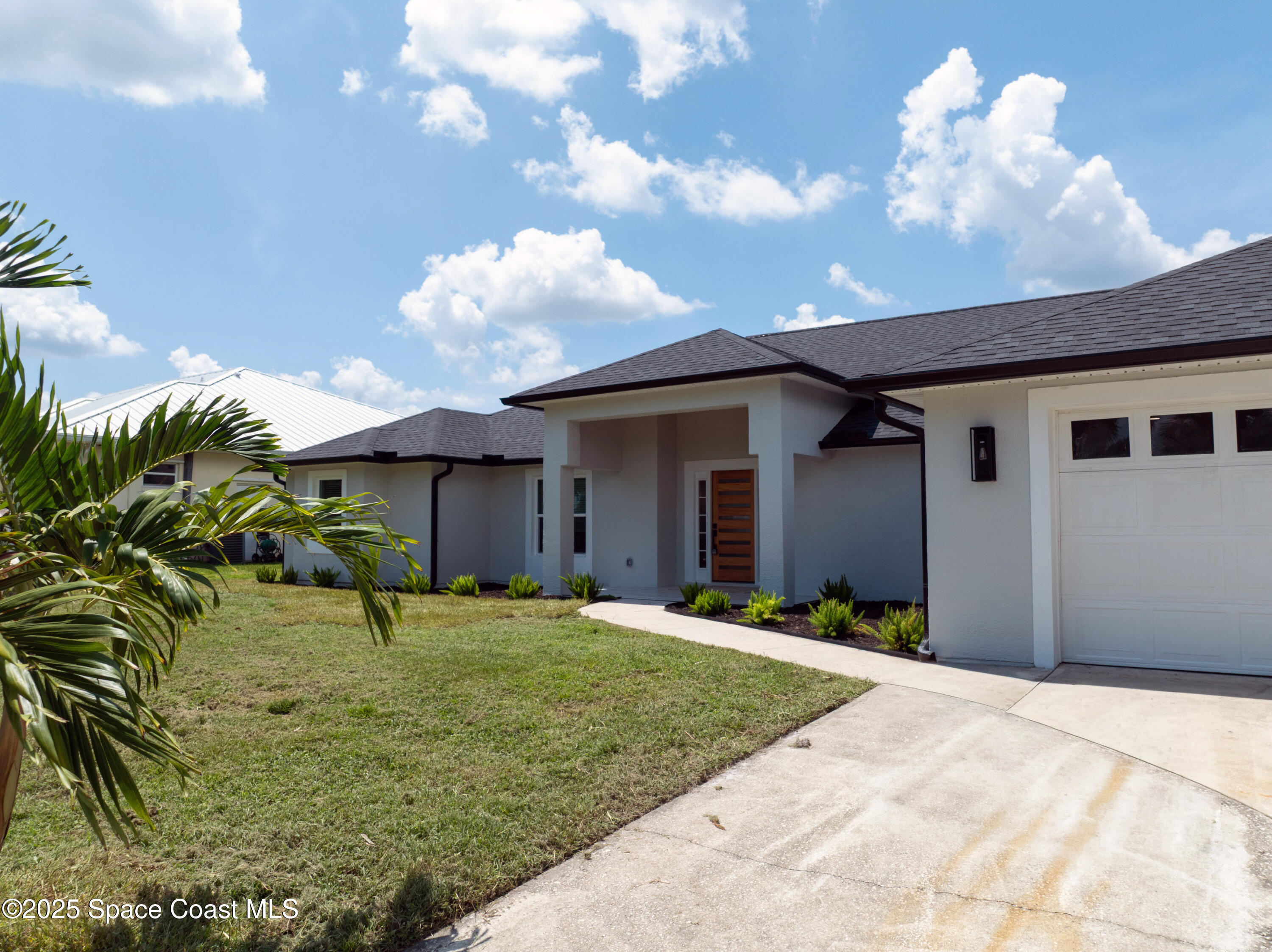 855 Cliftons Cove Court Cocoa, FL 32926 - Photo 14 of 72 a front view of a house with a yard and garage