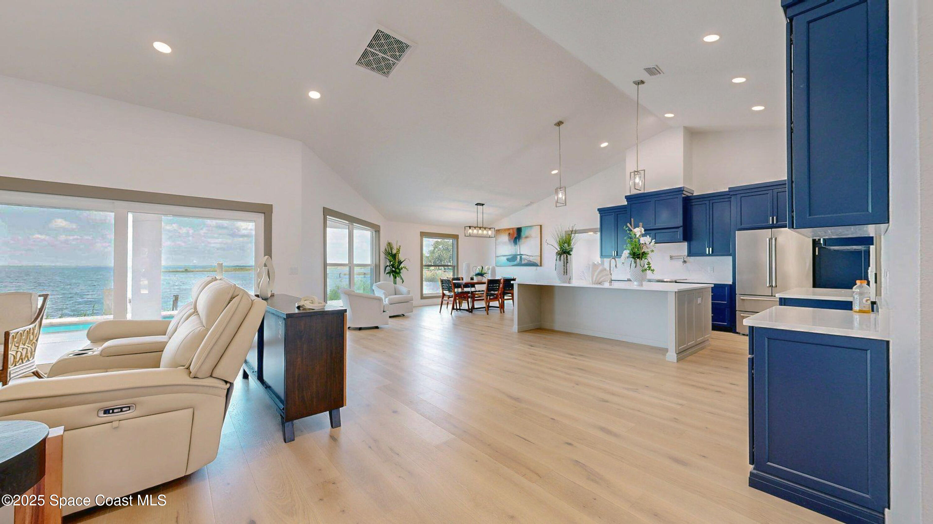 855 Cliftons Cove Court Cocoa, FL 32926 - Photo 16 of 72 a living room with couches and kitchen view with wooden floor