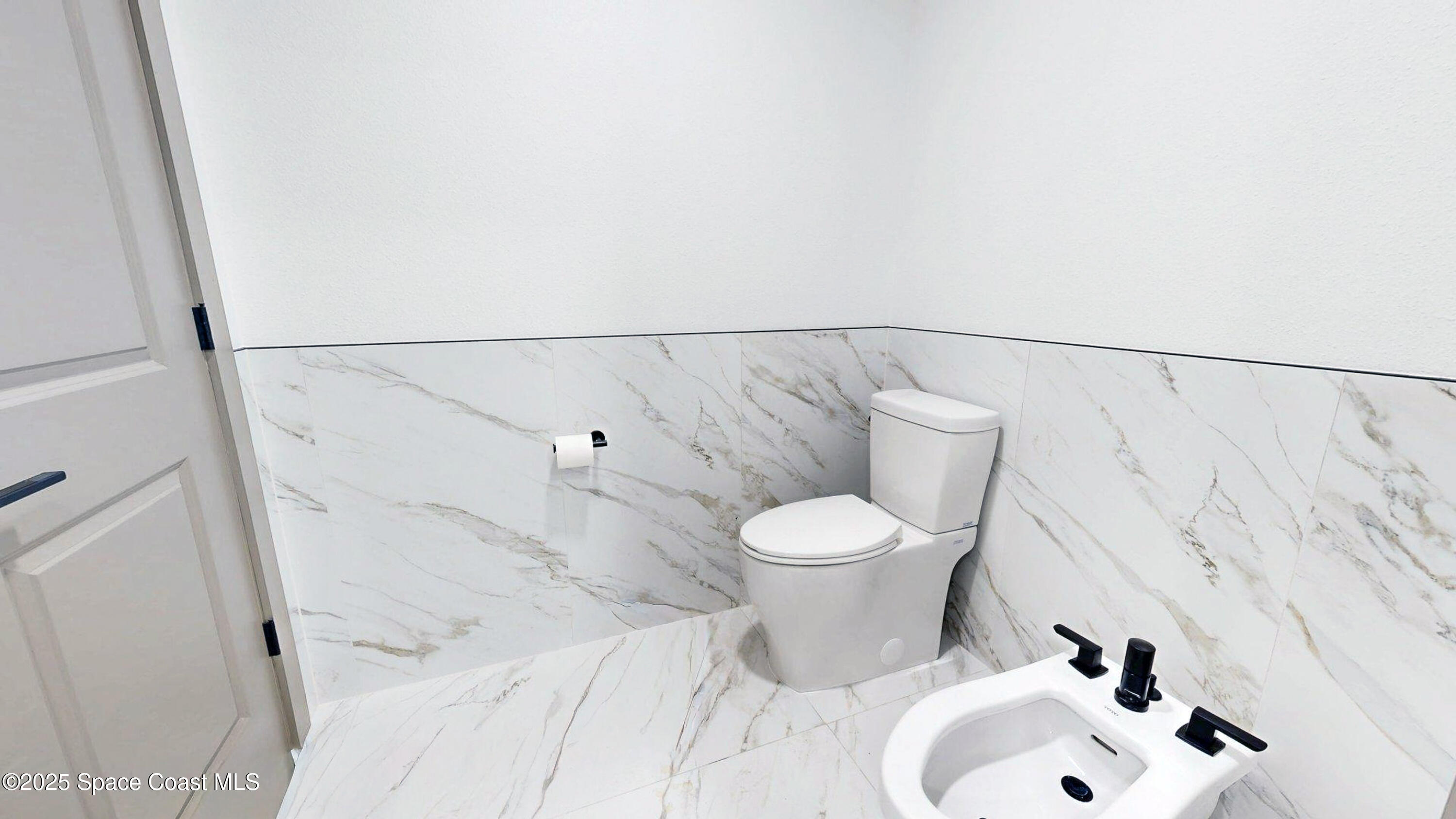 855 Cliftons Cove Court Cocoa, FL 32926 - Photo 41 of 72 a white toilet sitting next to a bathroom sink