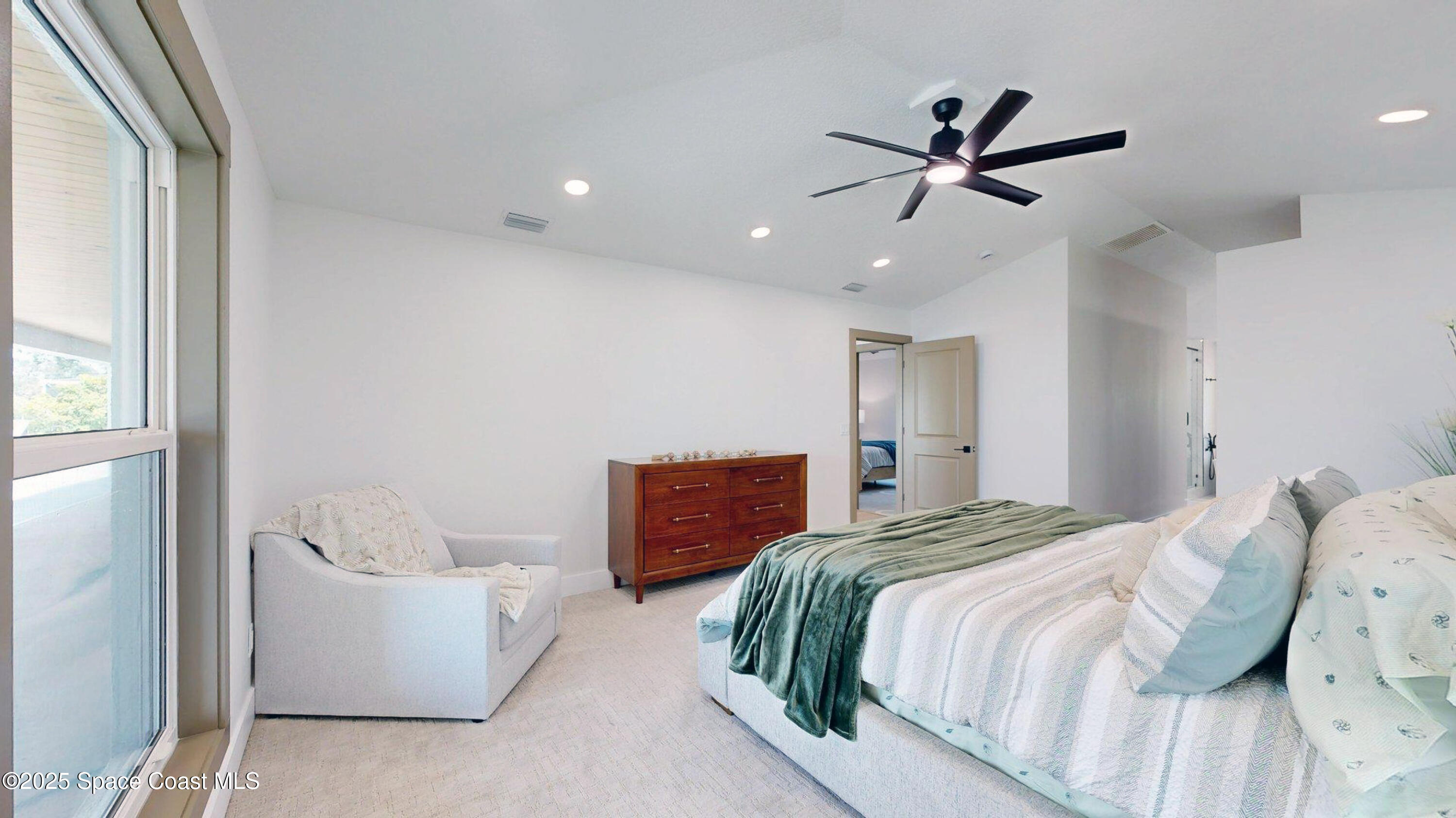 855 Cliftons Cove Court Cocoa, FL 32926 - Photo 50 of 72 a bedroom with a large bed and a chandelier