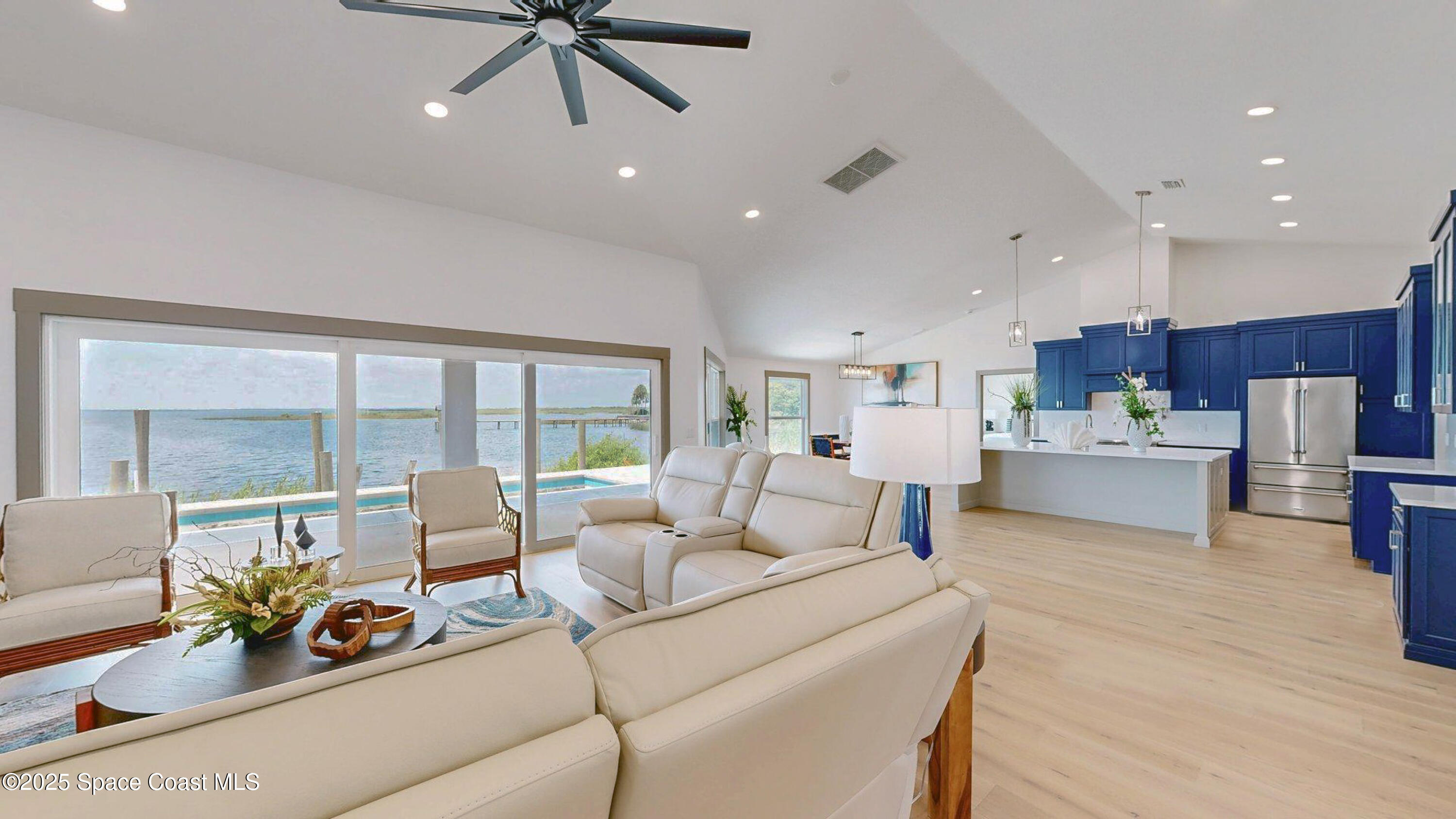 855 Cliftons Cove Court Cocoa, FL 32926 - Photo 59 of 72 a living room with furniture and a large window with kitchen view