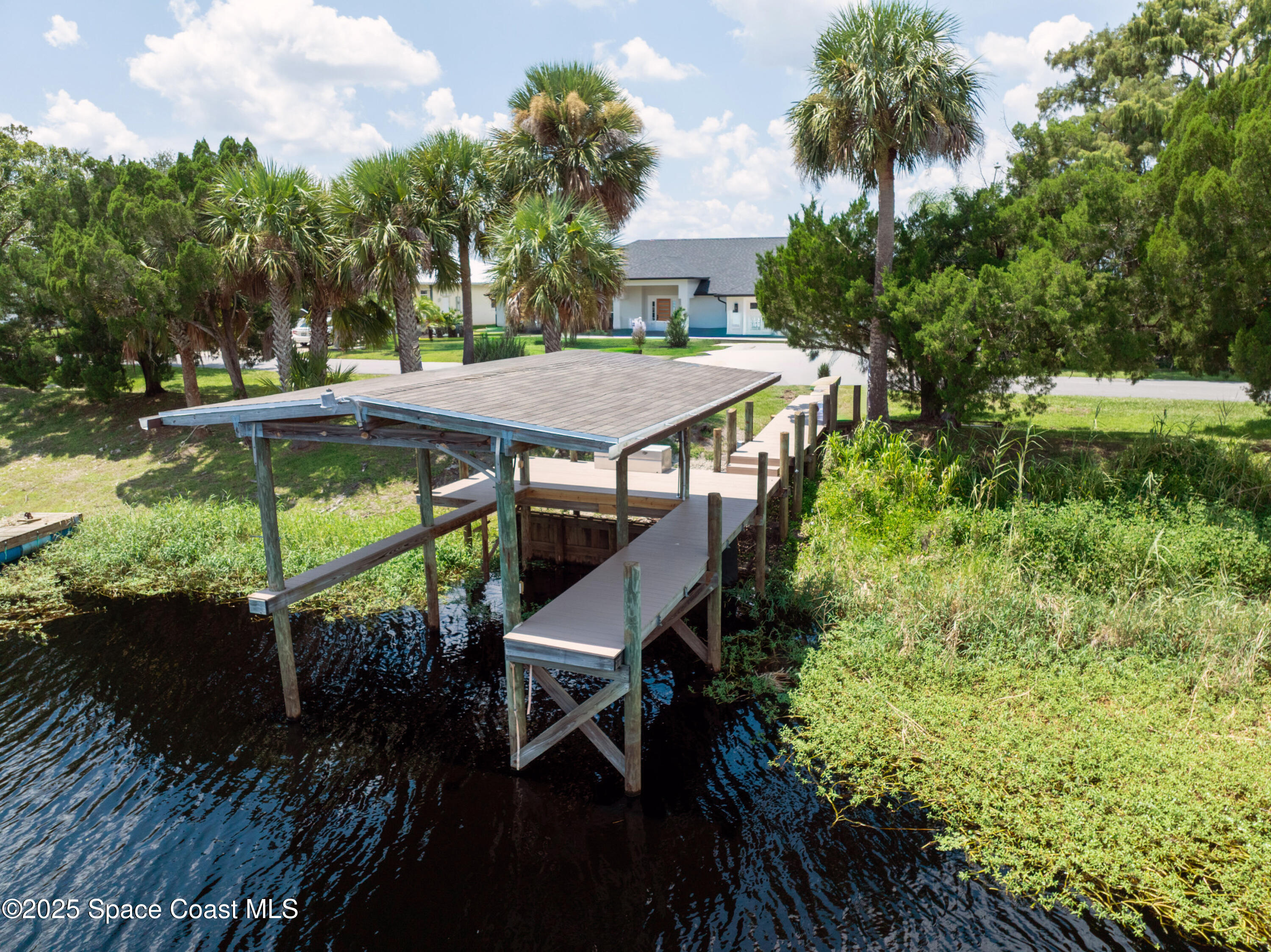 855 Cliftons Cove Court Cocoa, FL 32926 - Photo 6 of 72 a view of a patio with table and chairs under an umbrella with wooden floor