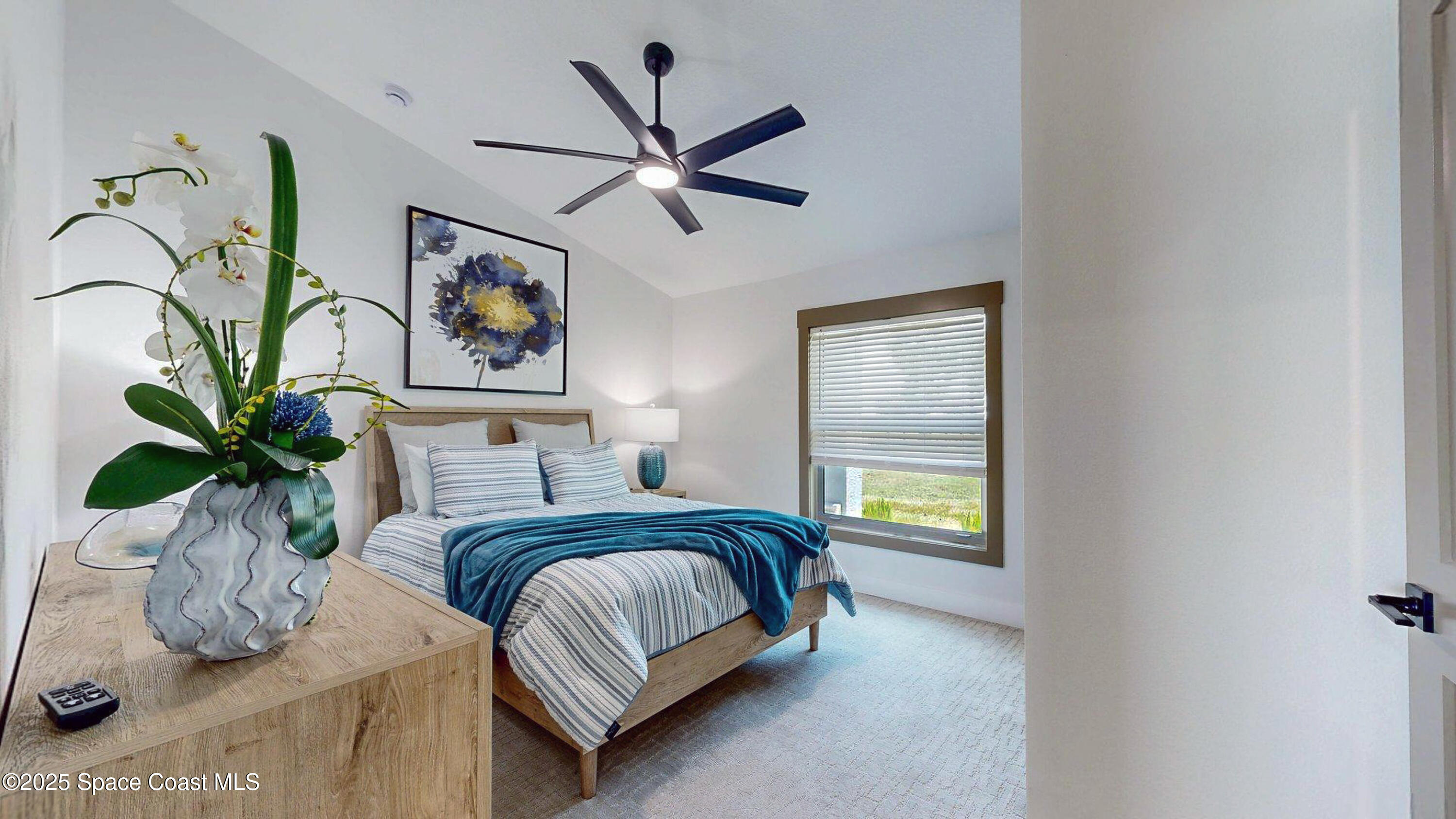 855 Cliftons Cove Court Cocoa, FL 32926 - Photo 66 of 72 a bedroom with a bed and a painting on the wall