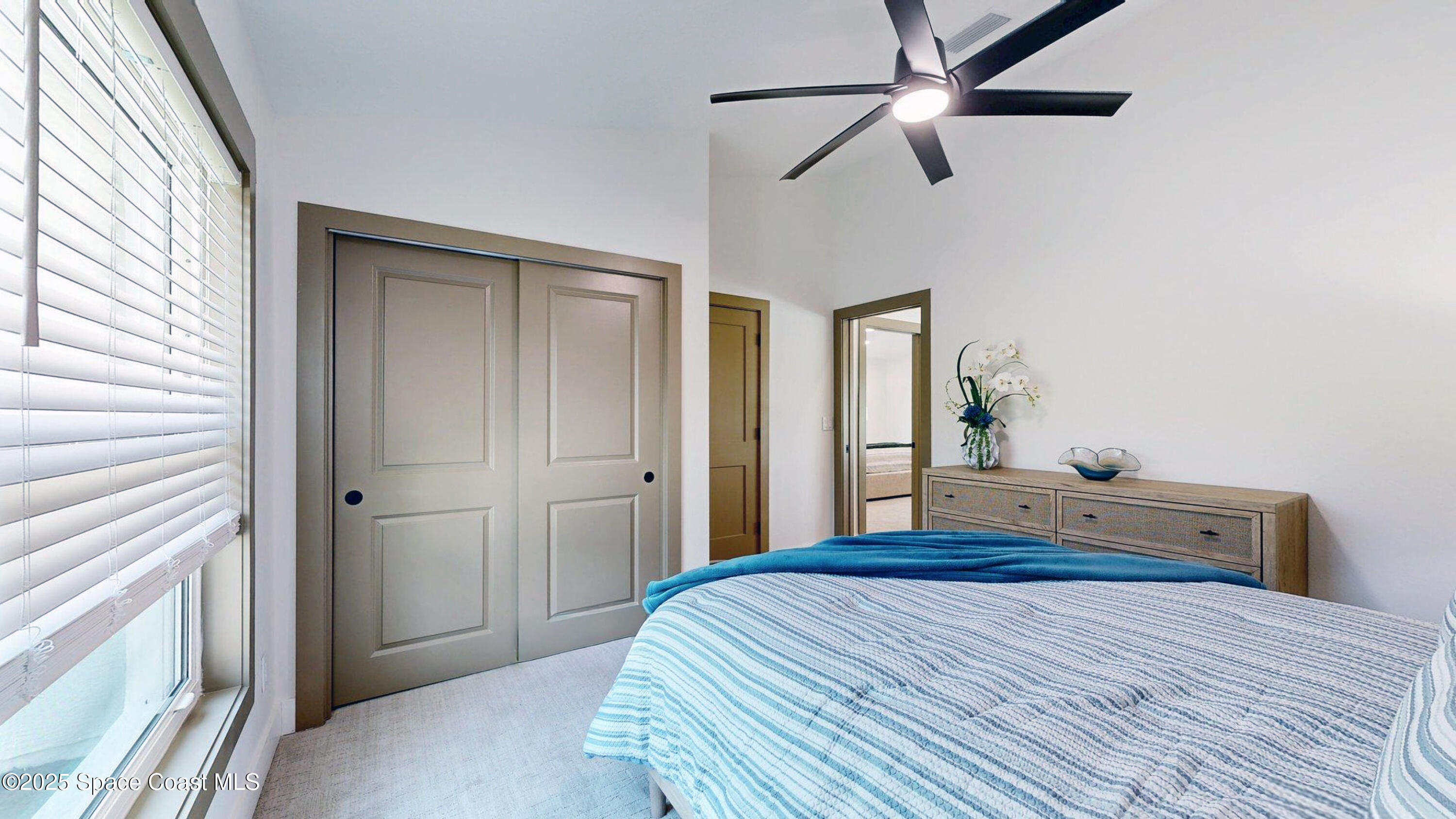 855 Cliftons Cove Court Cocoa, FL 32926 - Photo 67 of 72 a bedroom with a bed and a chandelier