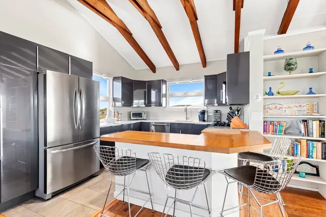 a kitchen with stainless steel appliances granite countertop a refrigerator and a stove