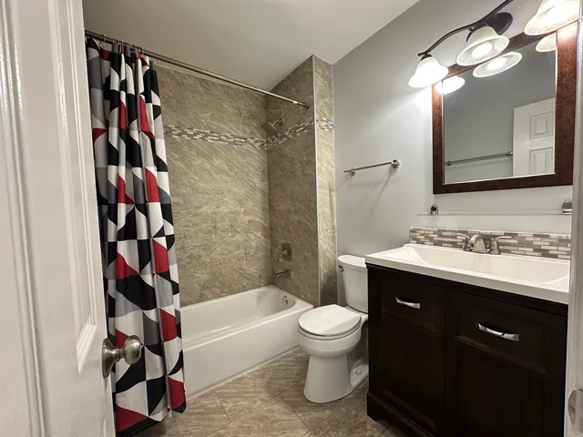 a bathroom with a sink toilet and shower