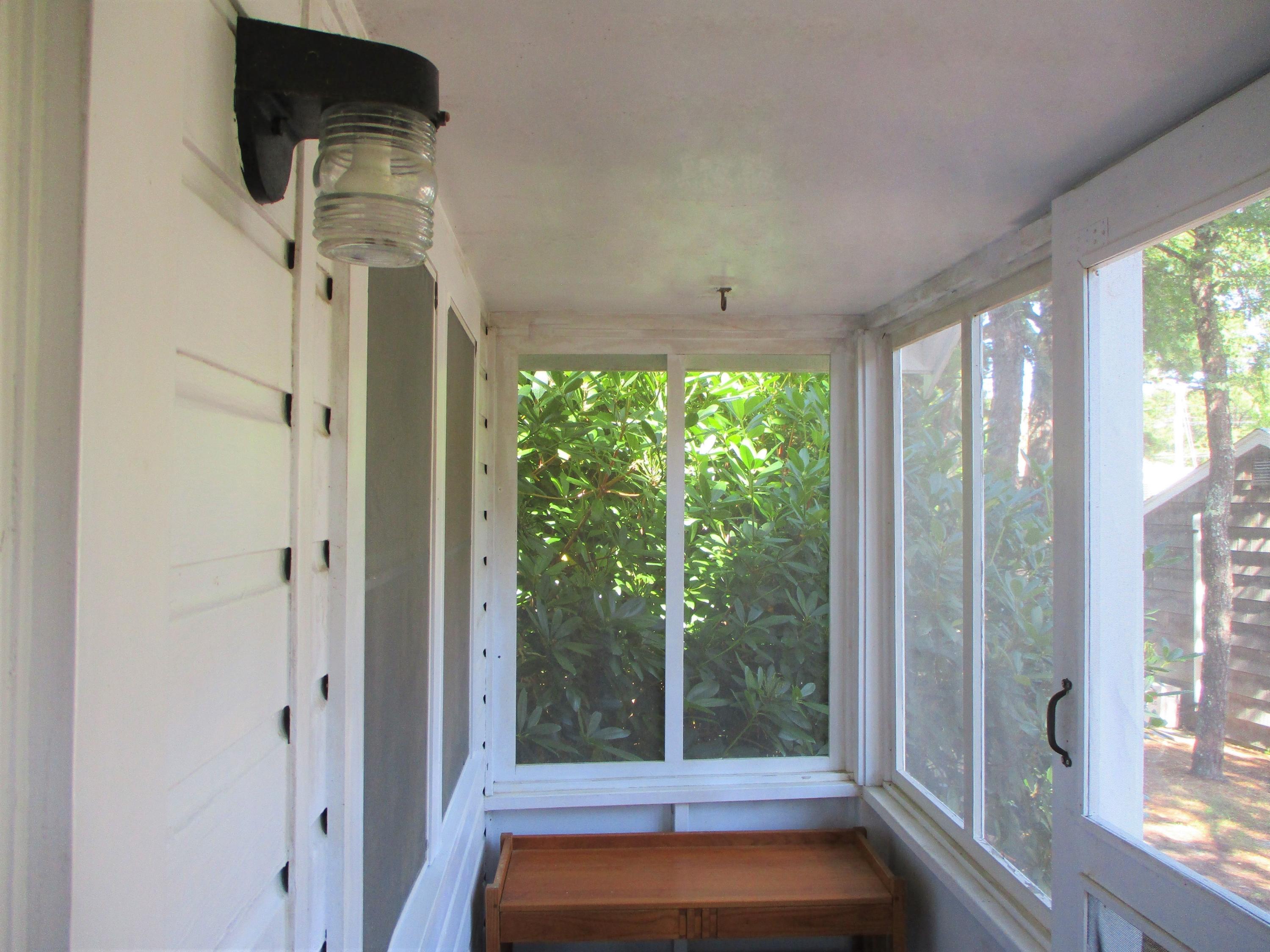 82 Shore Road, Unit 11 Truro, MA 02666 - Photo 5 of 22 a view of a room with wooden floor and windows