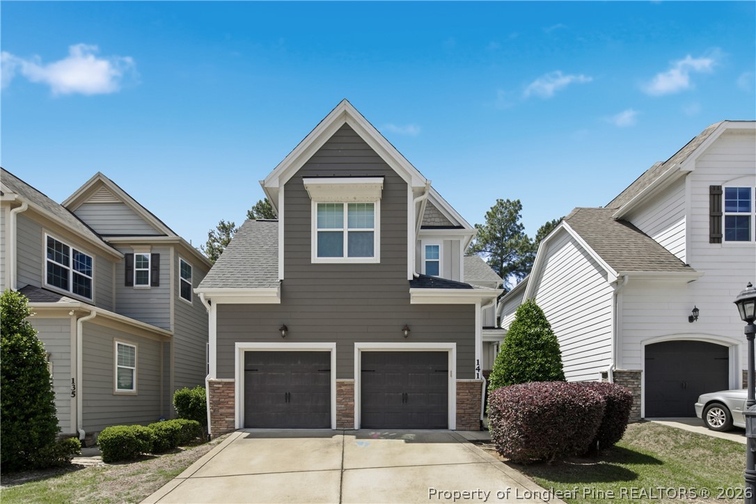 141 Pine Hawk Drive Spring Lake, NC 28390 - Photo 2 of 21 a front view of a house with a garage