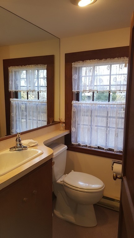 3 Brooks Road Rockport, MA 01966 - Photo 12 of 26 a bathroom with a granite countertop toilet sink and mirror