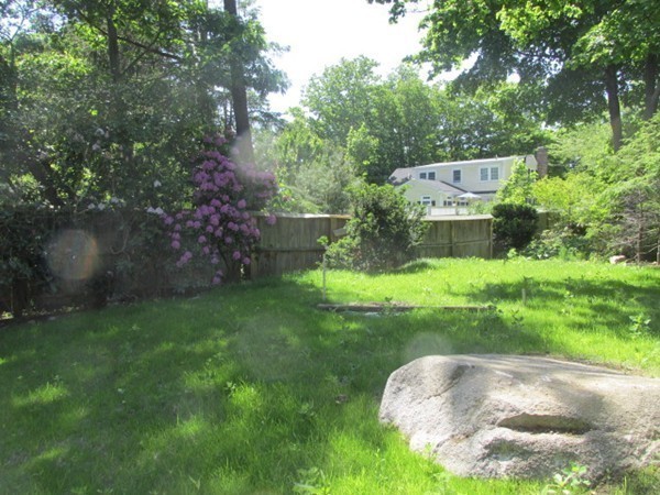 3 Brooks Road Rockport, MA 01966 - Photo 22 of 26 a view of a garden with a bench
