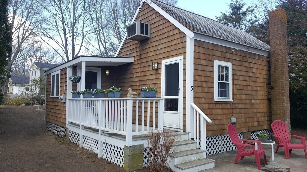 3 Brooks Road Rockport, MA 01966 - Photo 3 of 26 a view of a wooden deck with a bench
