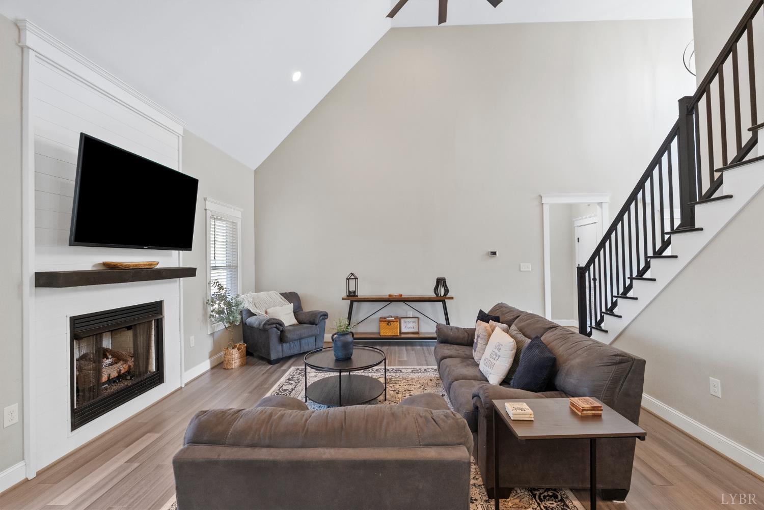 835 Sunset Ridge Drive Concord, VA 24538 - Photo 11 of 57 a living room with furniture a fireplace and a flat screen tv