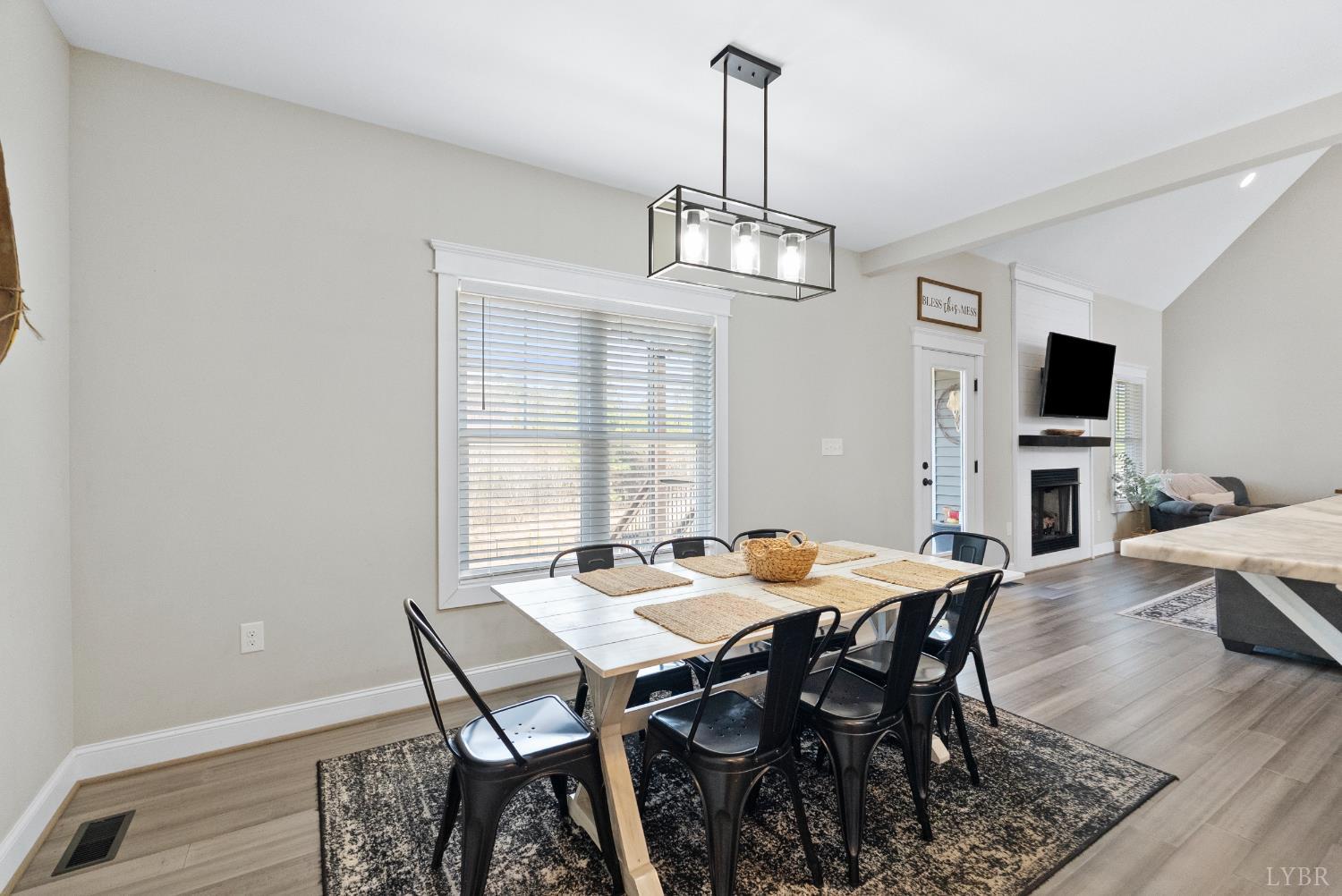 835 Sunset Ridge Drive Concord, VA 24538 - Photo 13 of 57 a view of a dining room with furniture a chandelier and wooden floor