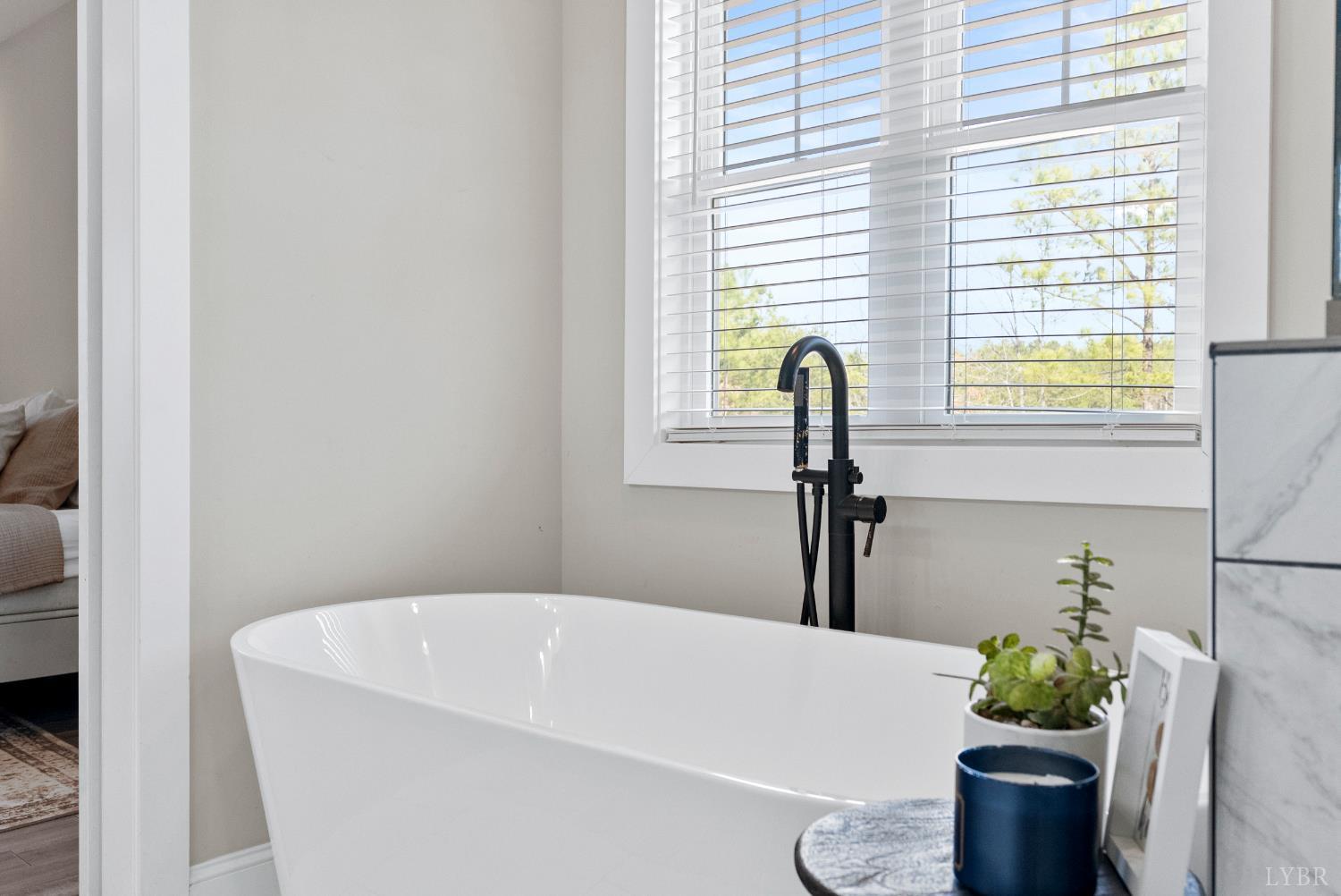 835 Sunset Ridge Drive Concord, VA 24538 - Photo 22 of 57 a bath tub sitting in a bathroom next to a window