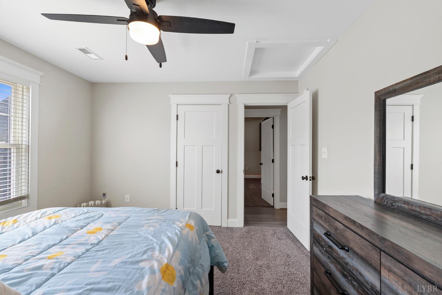 835 Sunset Ridge Drive Concord, VA 24538 - Photo 38 of 57 a bedroom with a bed and a chandelier