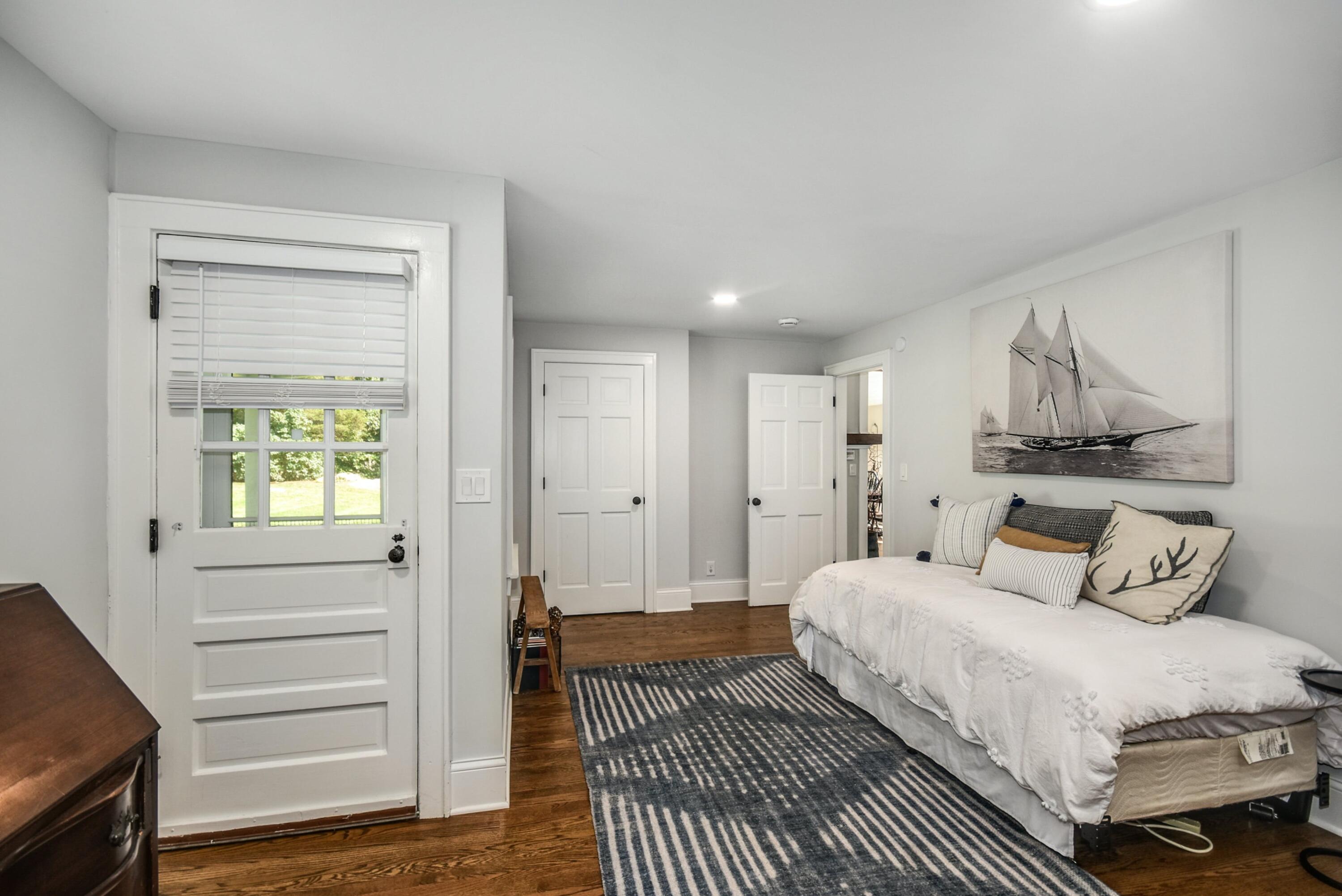 214 Millstone Road Wilton, CT 06897 - Photo 22 of 32 a bedroom with a bed and a window