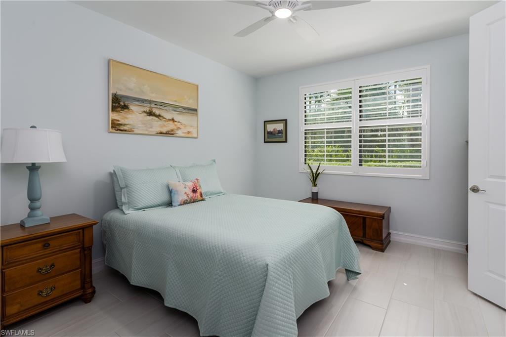 7336 Rockefeller Drive Naples, FL 34119 - Photo 13 of 50 a bedroom with a bed and a window