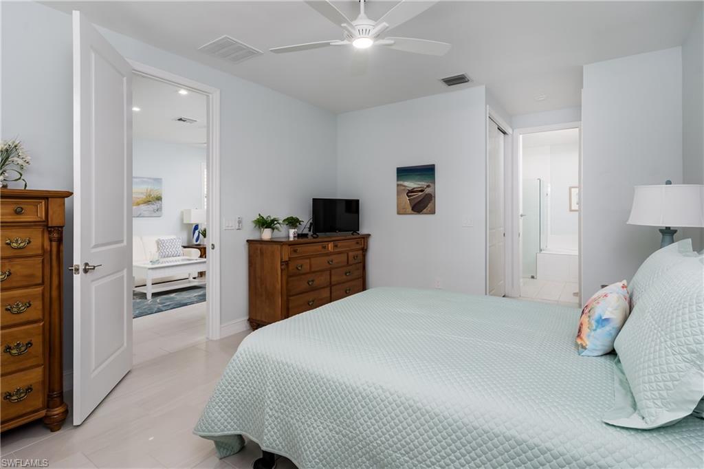 7336 Rockefeller Drive Naples, FL 34119 - Photo 14 of 50 a bedroom with a bed and a television