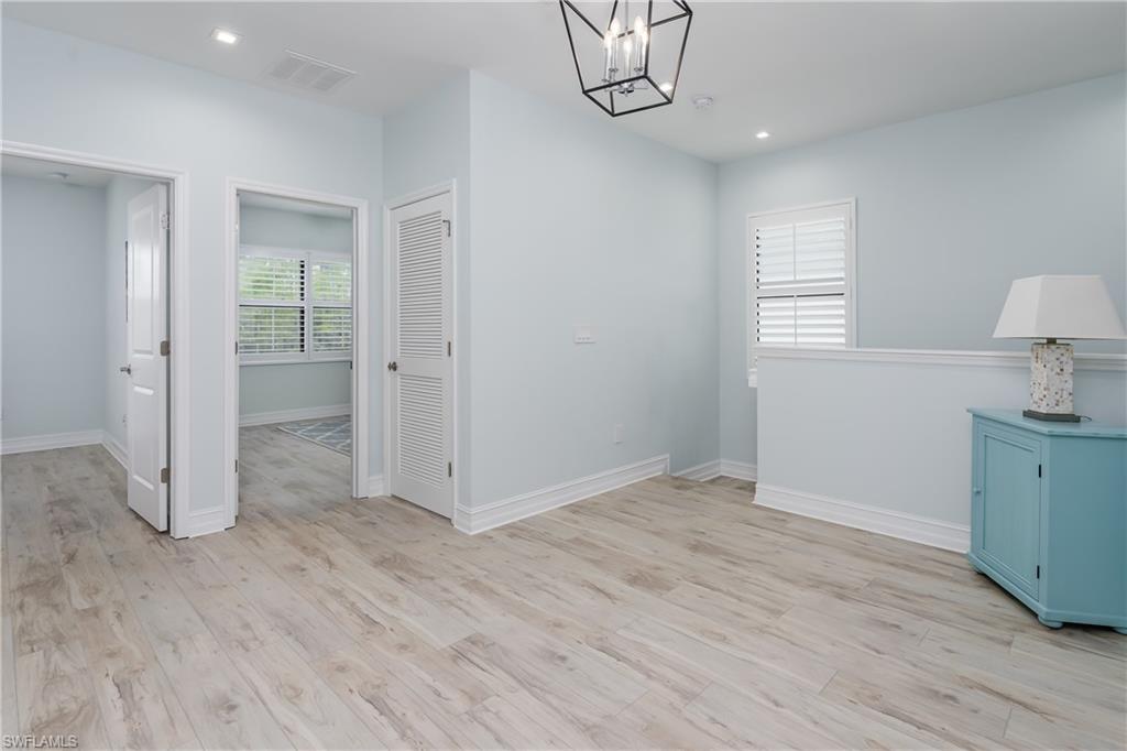 7336 Rockefeller Drive Naples, FL 34119 - Photo 15 of 50 wooden floor in an empty room with a window
