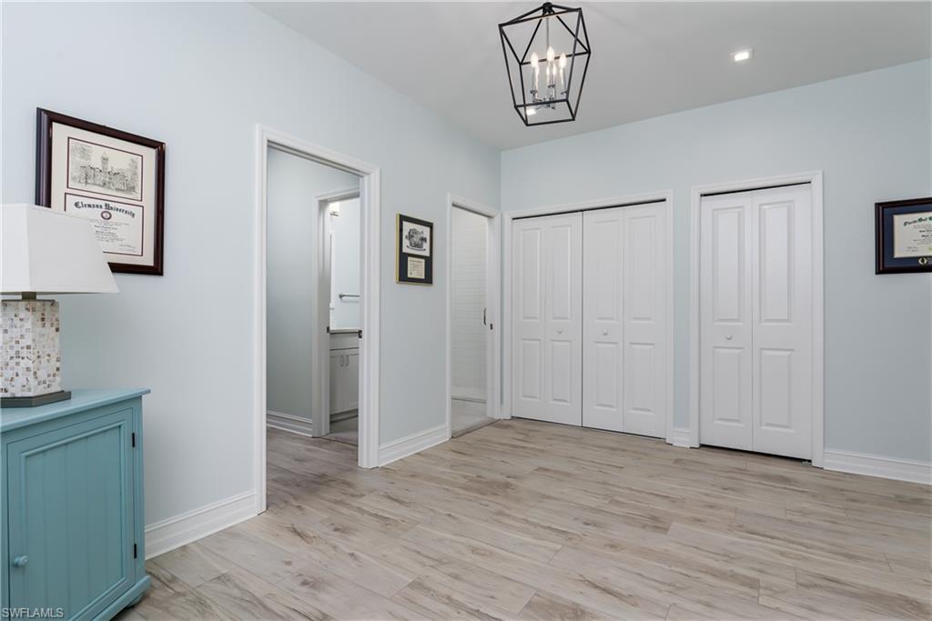 7336 Rockefeller Drive Naples, FL 34119 - Photo 16 of 50 a view of a livingroom with hardwood floor and hallway