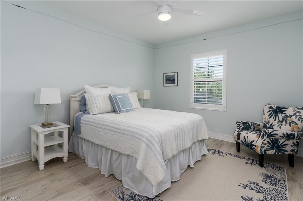 7336 Rockefeller Drive Naples, FL 34119 - Photo 20 of 50 a bedroom with a bed and a window