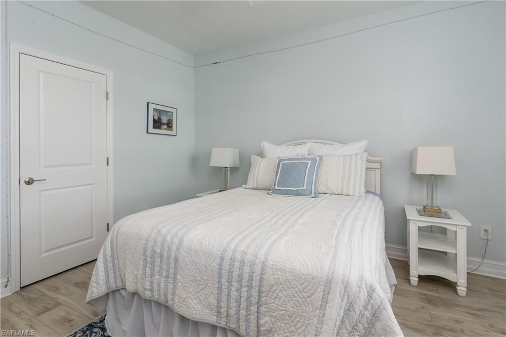 7336 Rockefeller Drive Naples, FL 34119 - Photo 21 of 50 a bedroom with a bed and a desk