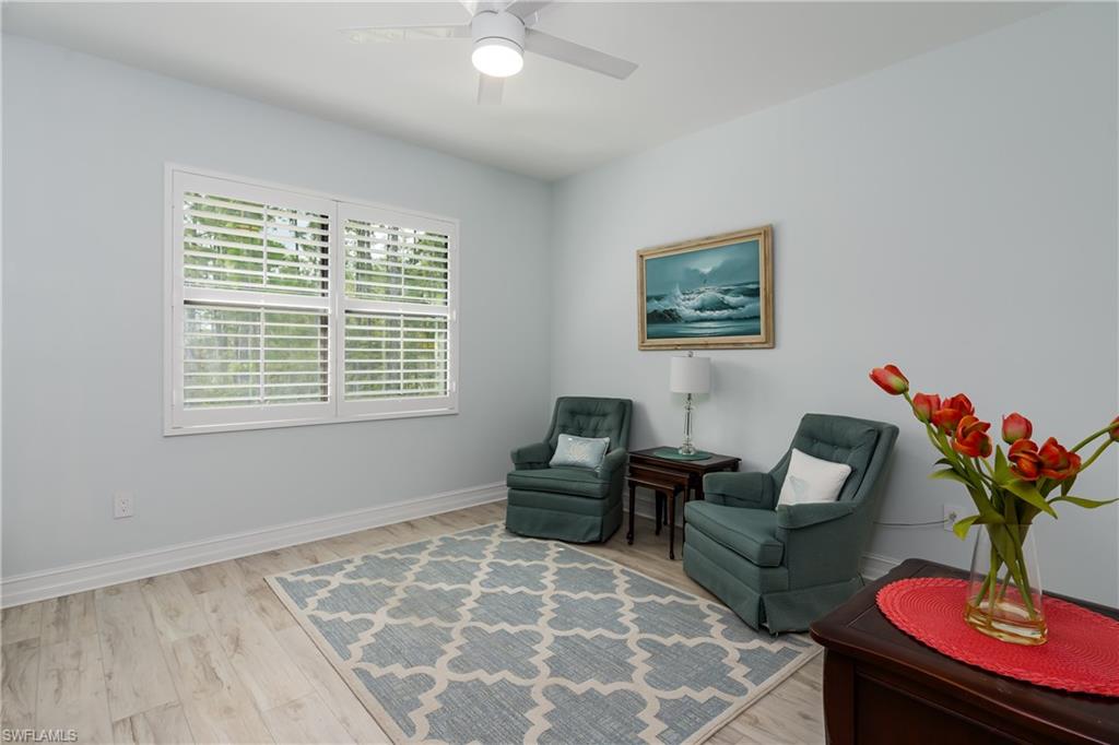 7336 Rockefeller Drive Naples, FL 34119 - Photo 23 of 50 a living room with furniture and a potted plant