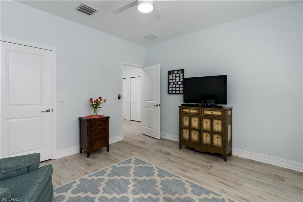 7336 Rockefeller Drive Naples, FL 34119 - Photo 24 of 50 a living room with furniture and flat screen tv
