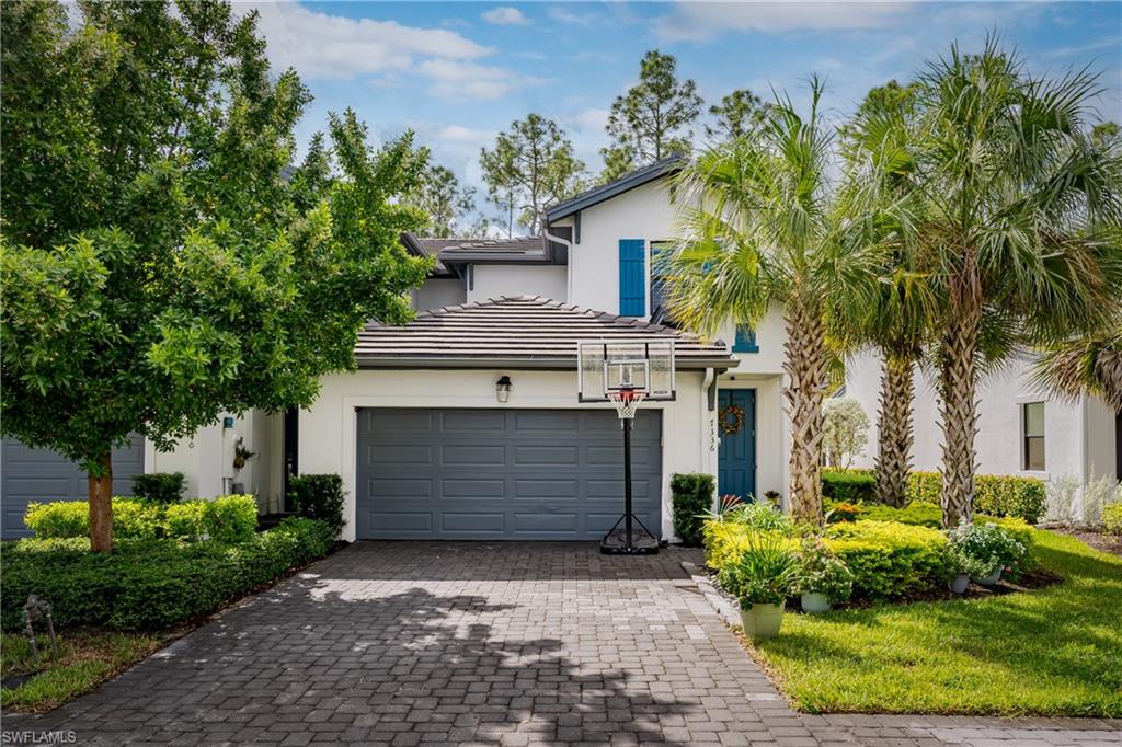 7336 Rockefeller Drive Naples, FL 34119 - Photo 30 of 50 a front view of a house with a garden
