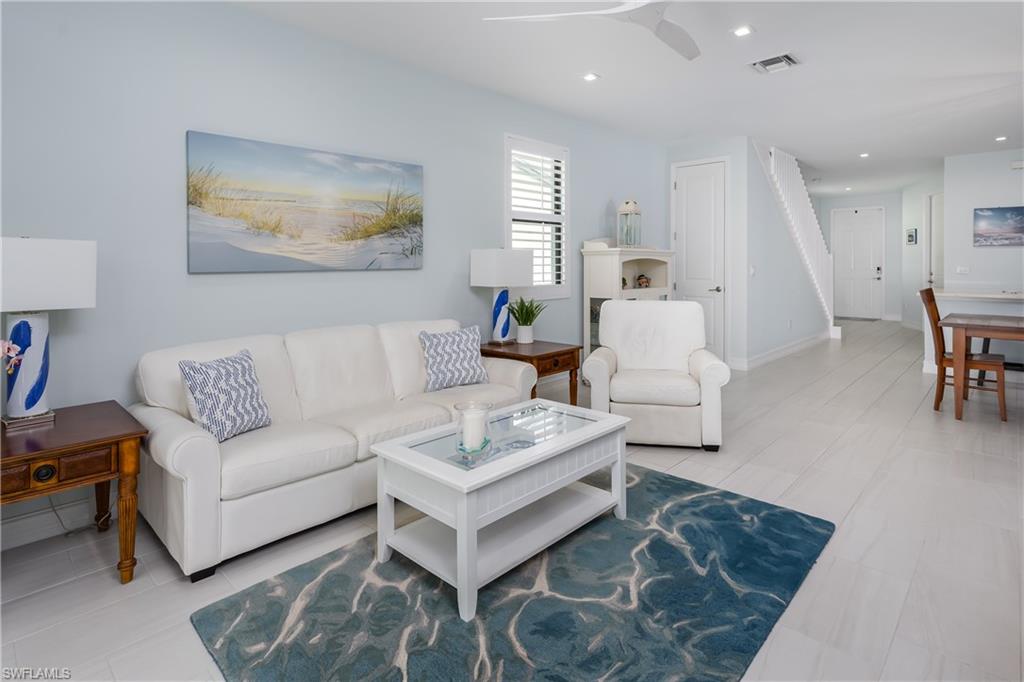 7336 Rockefeller Drive Naples, FL 34119 - Photo 3 of 50 a living room with furniture and wooden floor