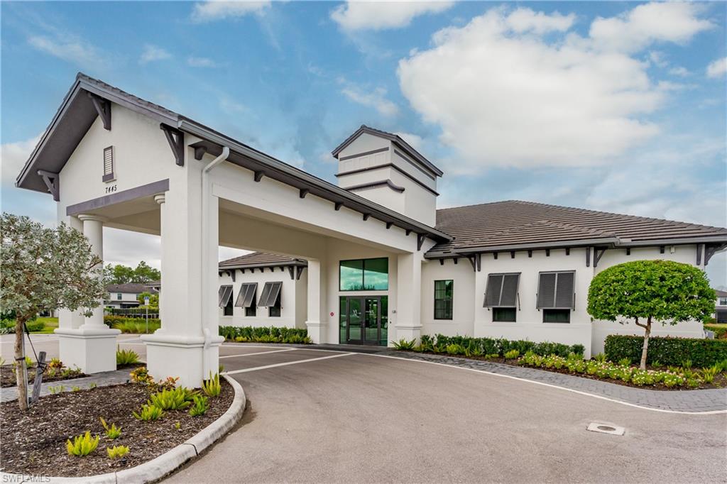 7336 Rockefeller Drive Naples, FL 34119 - Photo 35 of 50 front view of a house with a small yard and potted plants