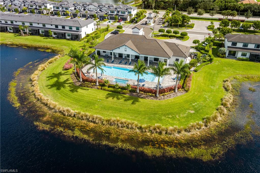 7336 Rockefeller Drive Naples, FL 34119 - Photo 38 of 50 a view of a swimming pool with outdoor seating and yard