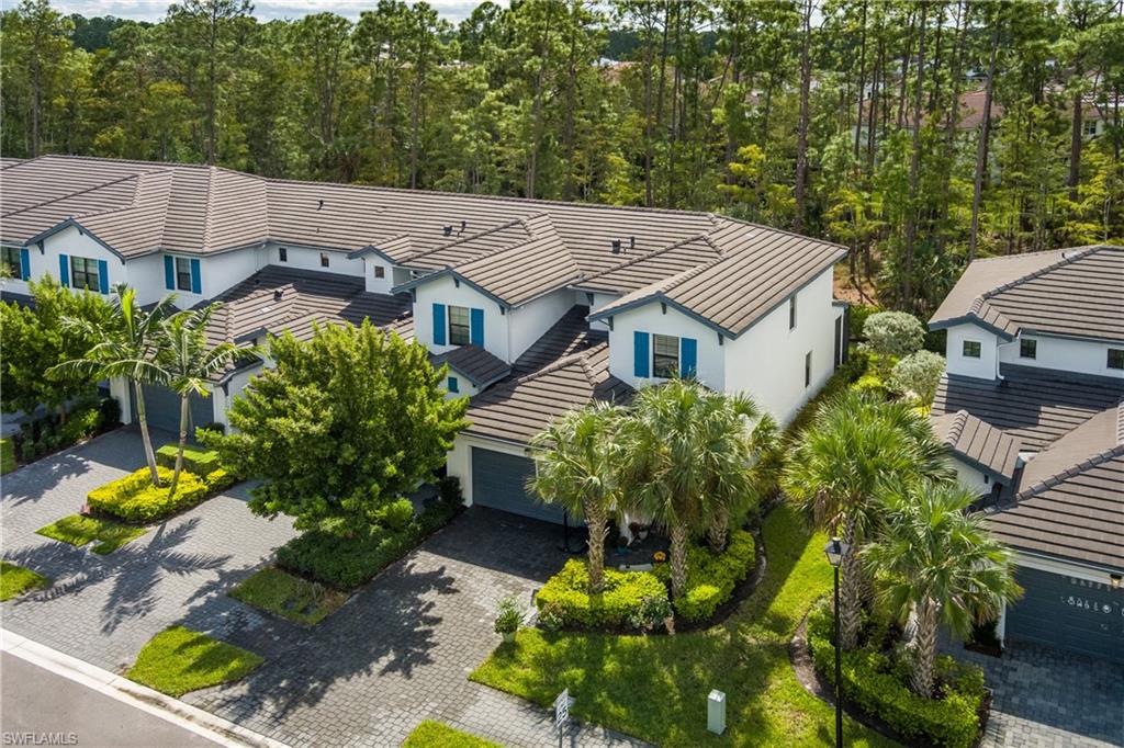 7336 Rockefeller Drive Naples, FL 34119 - Photo 41 of 50 an aerial view of a house with a big yard and large trees