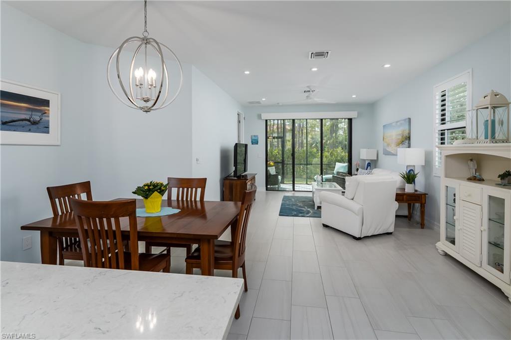 7336 Rockefeller Drive Naples, FL 34119 - Photo 5 of 50 a living room with fireplace furniture and a large window