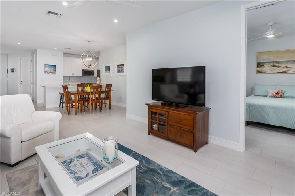 7336 Rockefeller Drive Naples, FL 34119 - Photo 6 of 50 a living room with furniture and a flat screen tv