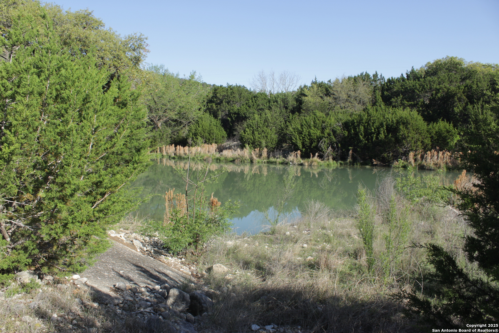 1976 Cedar Creek Road Leakey, TX 78873 - Photo 20 of 21 a view of a lake with green landscape