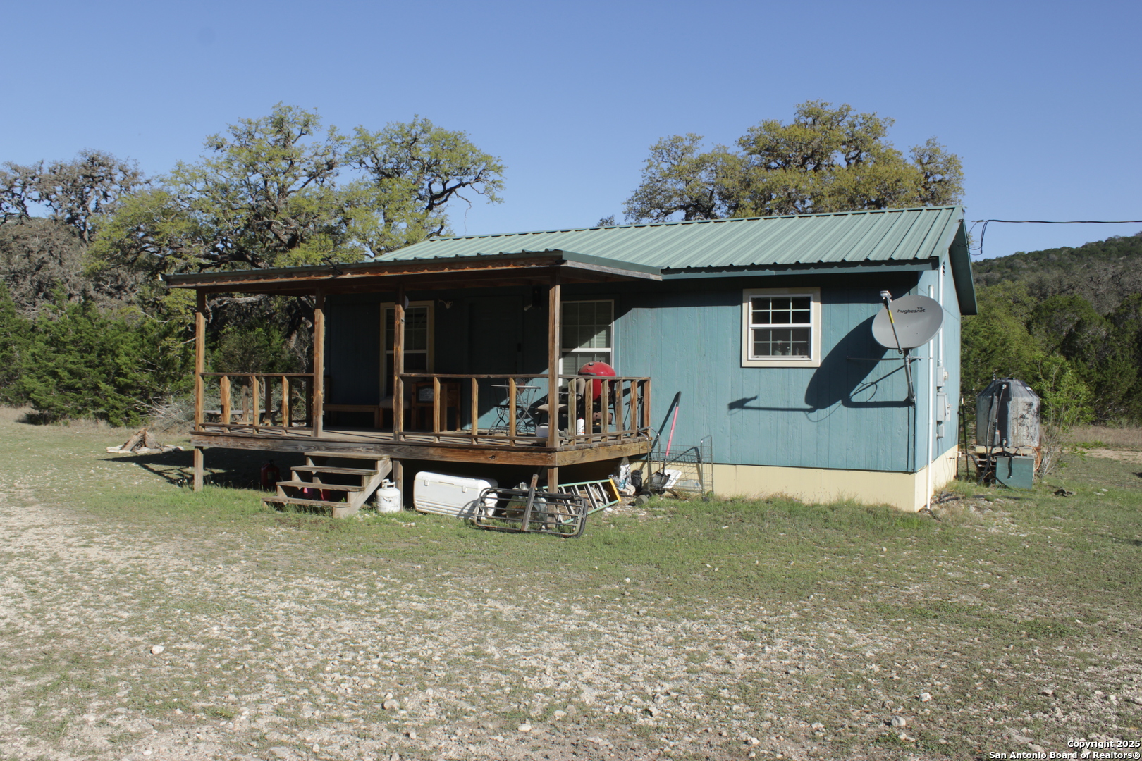 1976 Cedar Creek Road Leakey, TX 78873 - Photo 2 of 21 a backyard of a house with table and chairs