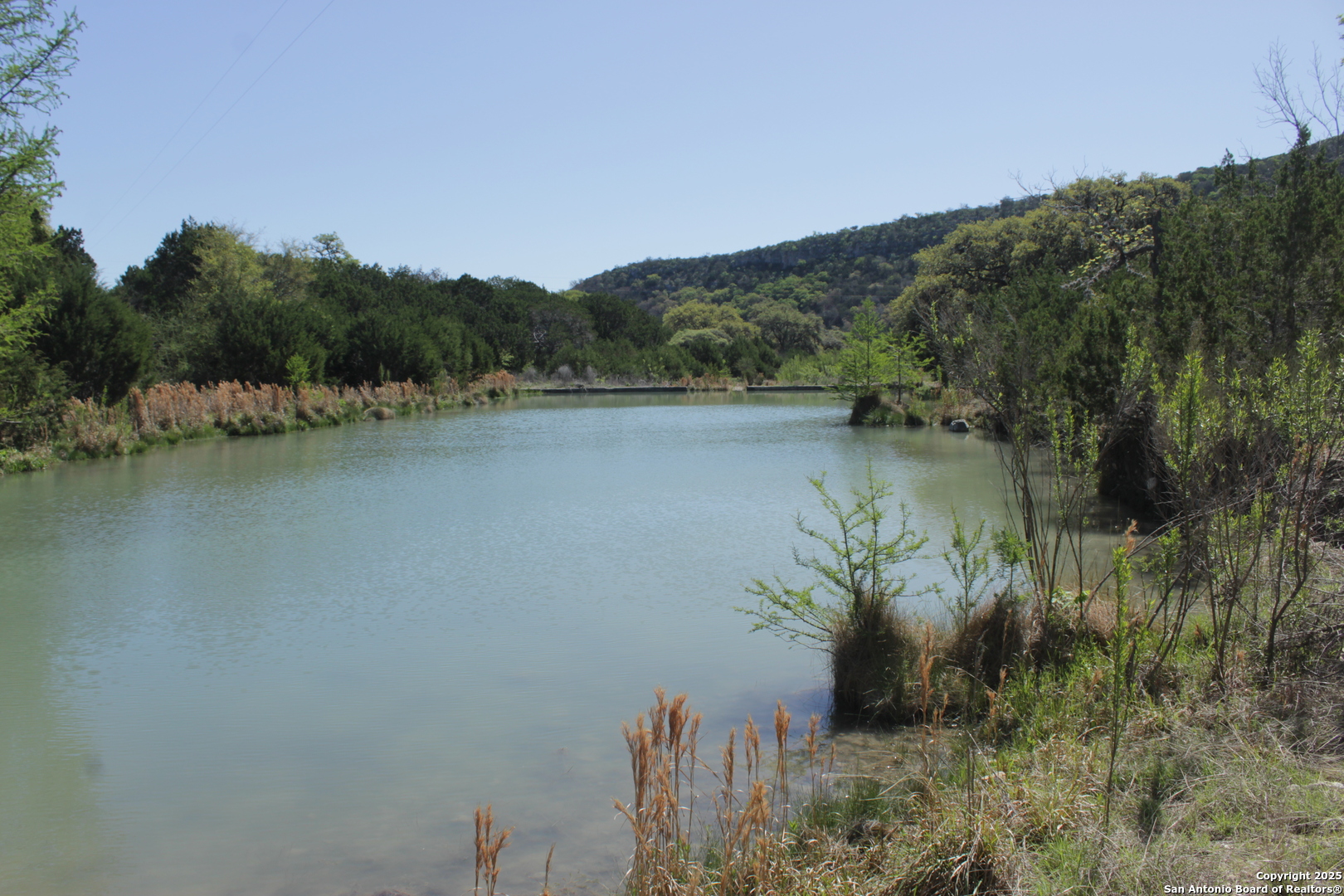 1976 Cedar Creek Road Leakey, TX 78873 - Photo 6 of 21 a view of a lake with houses in background