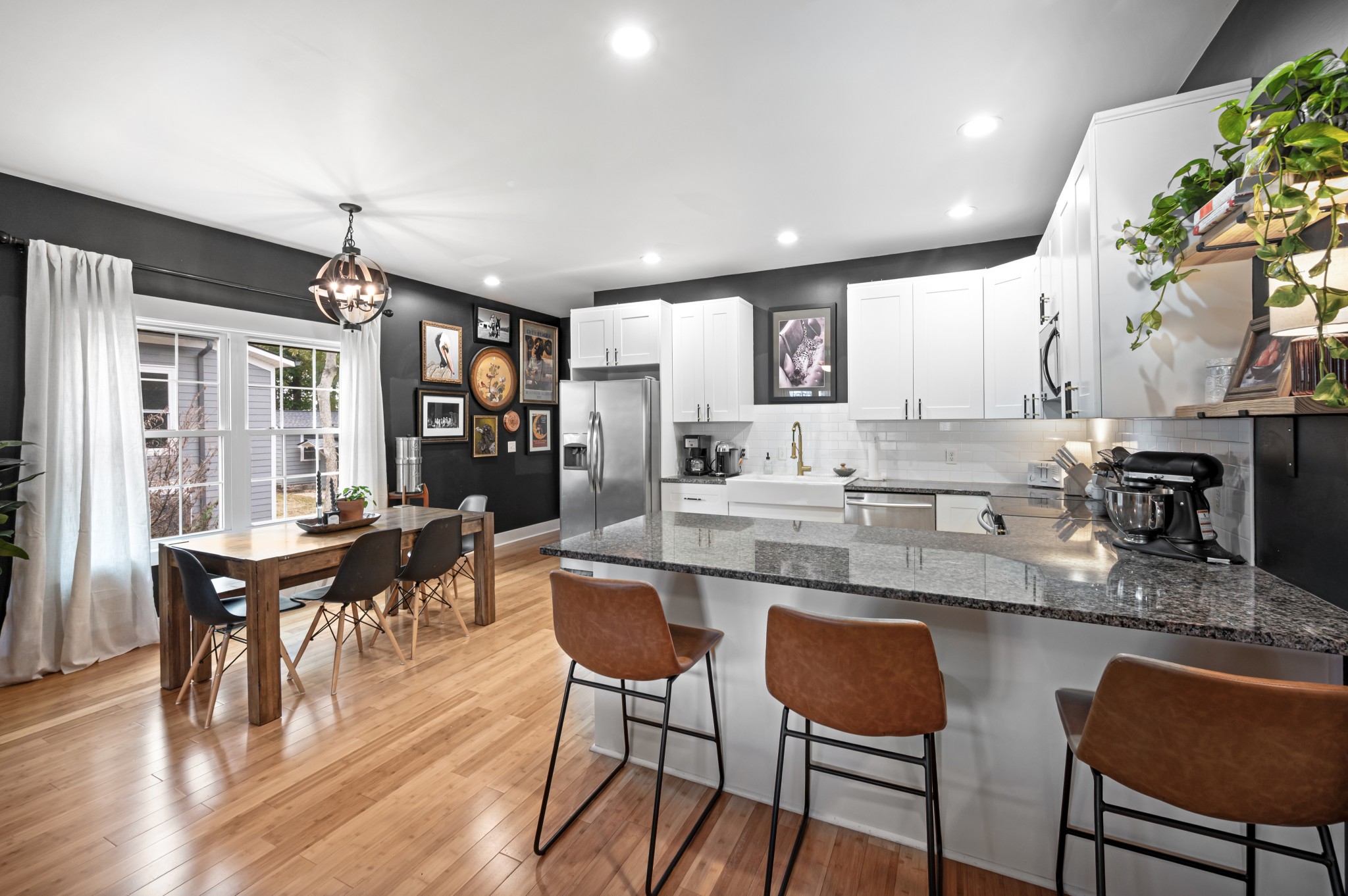 108 Poplar Street Dickson, TN 37055 - Photo 14 of 39 a kitchen with stainless steel appliances granite countertop table chairs and wooden floor